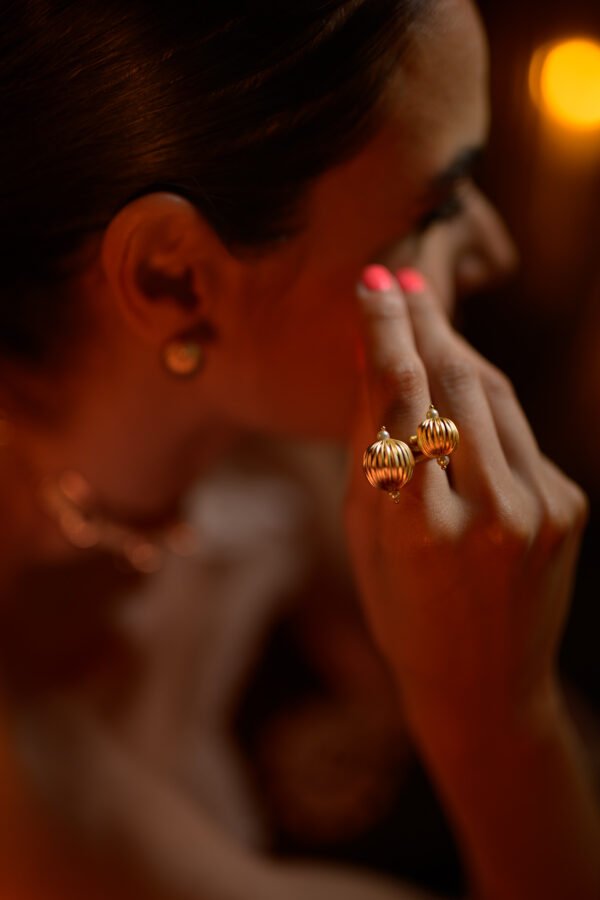 Faustina Stackable Ring with a 24k gold-plated finish, showcasing unique fluted gold spheres and delicate pearls. Ideal for elegant styling.