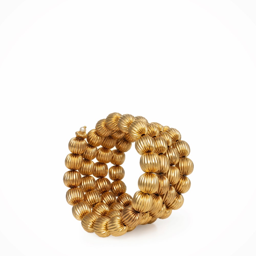 Close-up of the Aesira bracelet featuring multiple rows of finely crafted 24k gold-plated beads